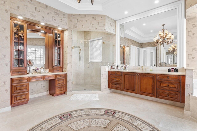 bathroom with vanity, a raised ceiling, a shower with shower door, and ornamental molding