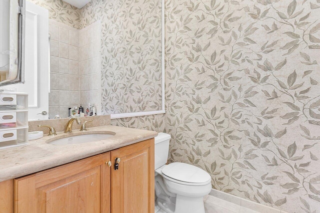 bathroom featuring tile patterned flooring, vanity, and toilet