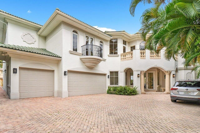 mediterranean / spanish-style house featuring a balcony and a garage