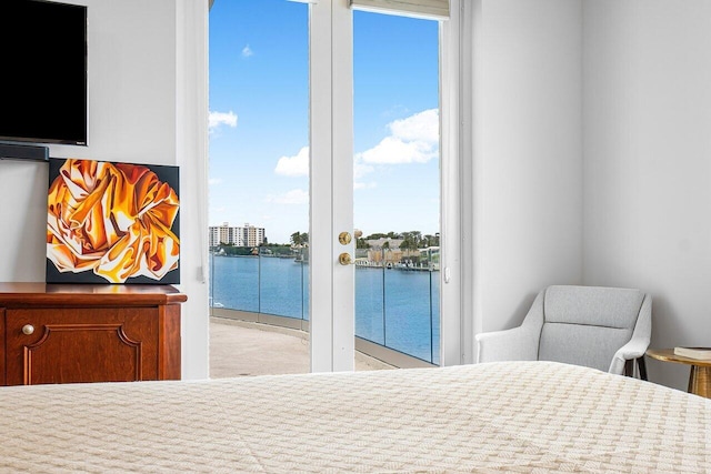 bedroom featuring access to exterior and a water view