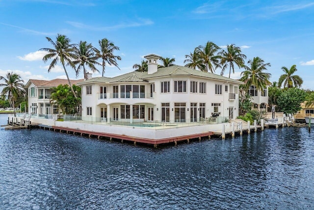 rear view of property with a water view