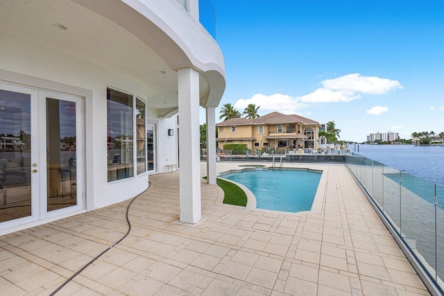 view of swimming pool featuring a patio area and a water view