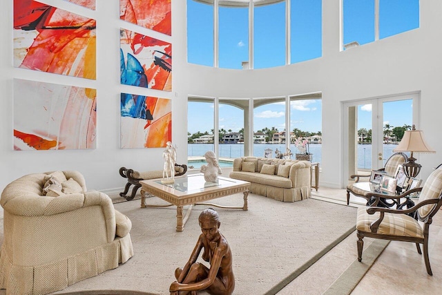 living room with french doors and a water view