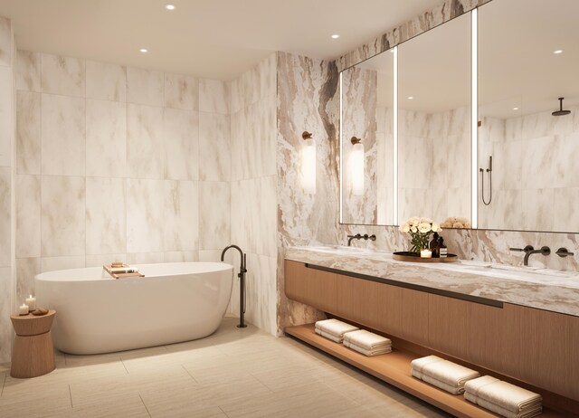 bathroom featuring double vanity, a soaking tub, walk in shower, tile walls, and recessed lighting