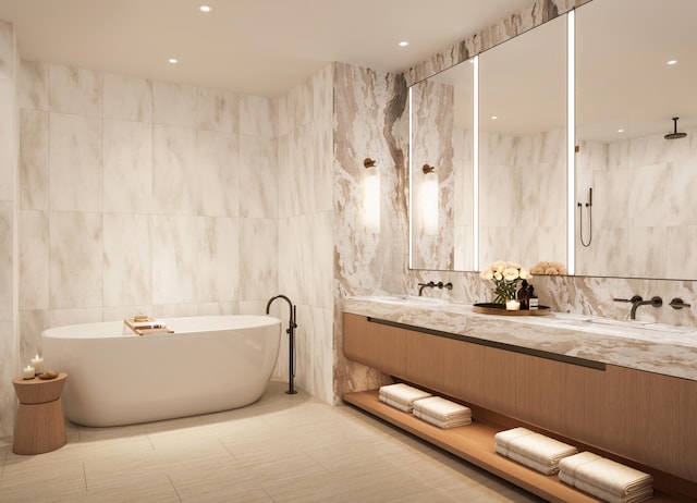 bathroom featuring a tub, vanity, and tile walls