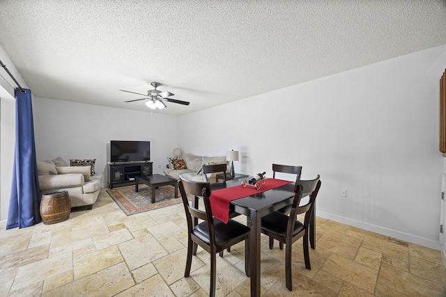 dining space with a textured ceiling and ceiling fan