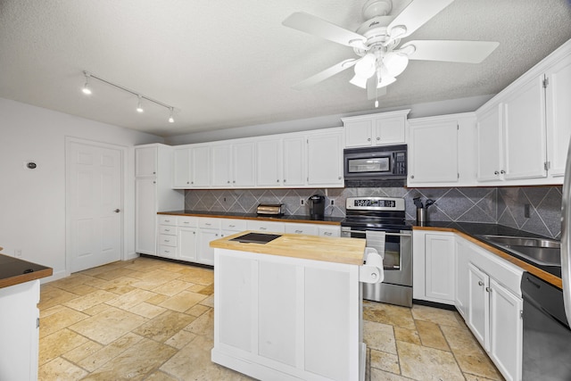 kitchen featuring butcher block counters, ceiling fan, decorative backsplash, white cabinets, and black appliances