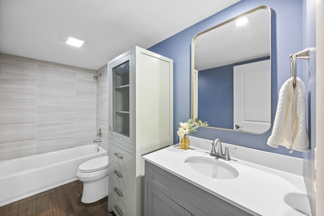 full bathroom with toilet, vanity, tiled shower / bath combo, and hardwood / wood-style flooring