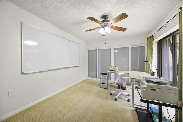 home office with ceiling fan, light colored carpet, a textured ceiling, and french doors