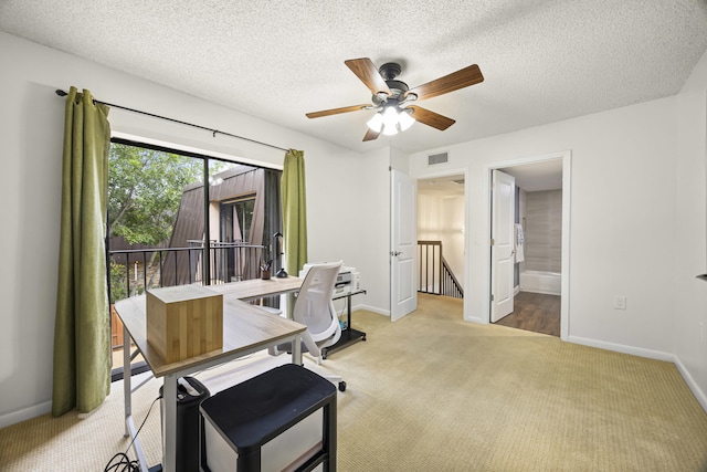 dining area featuring light carpet, a textured ceiling, and ceiling fan