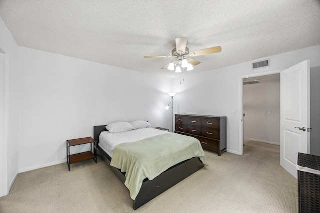 carpeted bedroom with a textured ceiling and ceiling fan