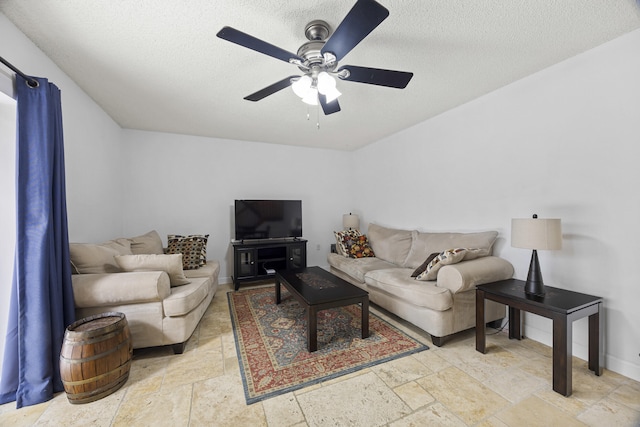 living room with ceiling fan and a textured ceiling