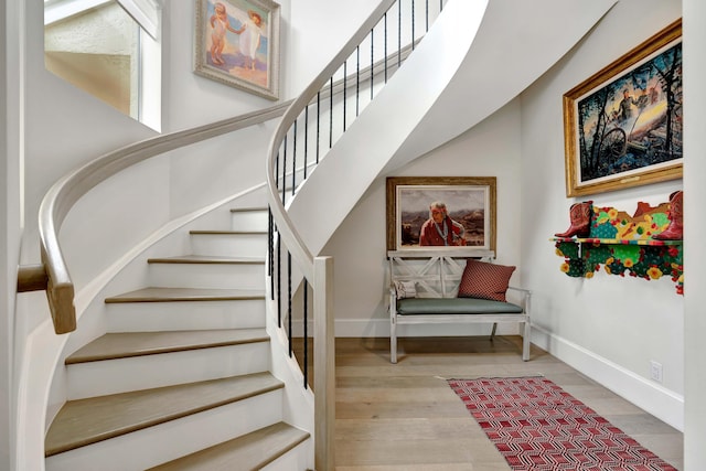 stairway featuring wood-type flooring