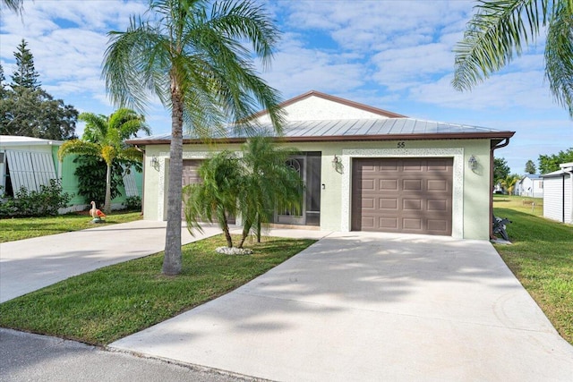 view of front facade featuring a front lawn and a garage