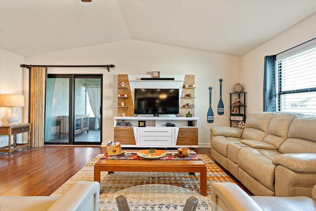 living room featuring hardwood / wood-style flooring and lofted ceiling