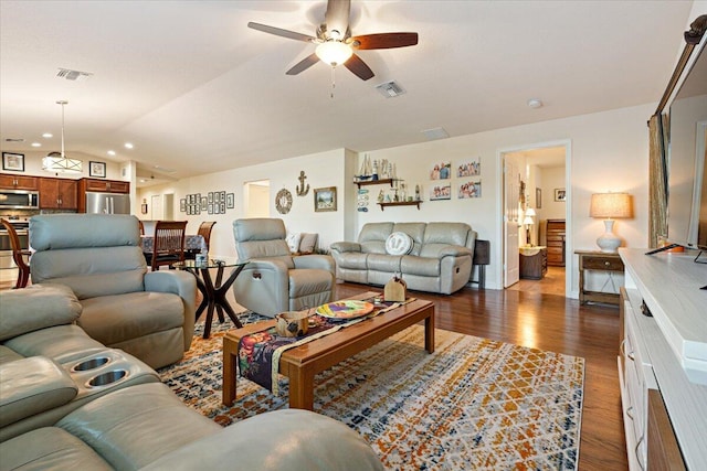 living room with ceiling fan, dark wood-type flooring, and lofted ceiling