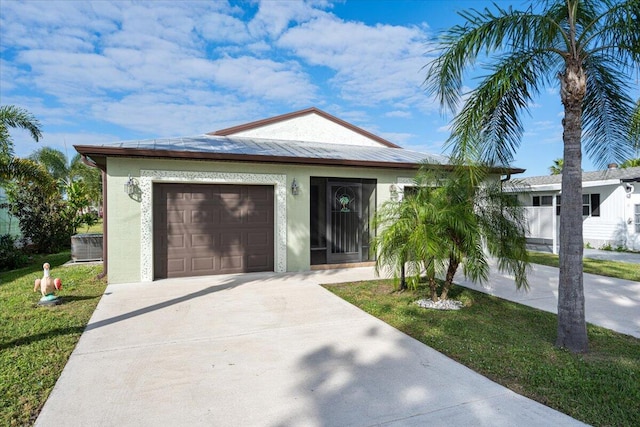 view of front of property with a front yard and a garage