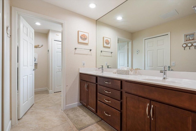 bathroom with tile patterned flooring and vanity