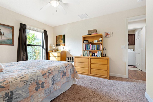 carpeted bedroom with washer / dryer and ceiling fan