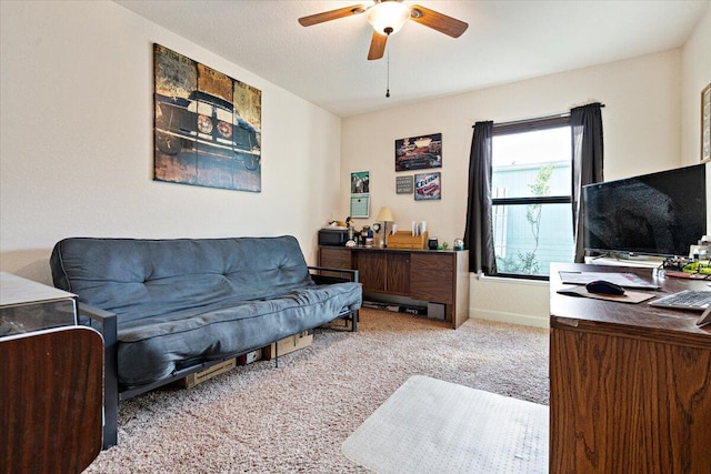 carpeted living room with ceiling fan