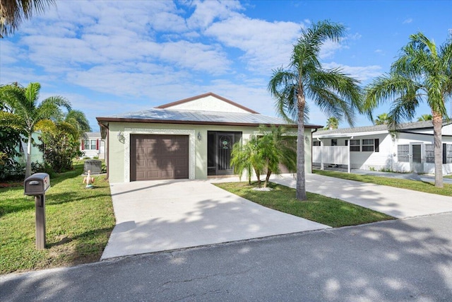 view of front of house featuring a front yard and a garage