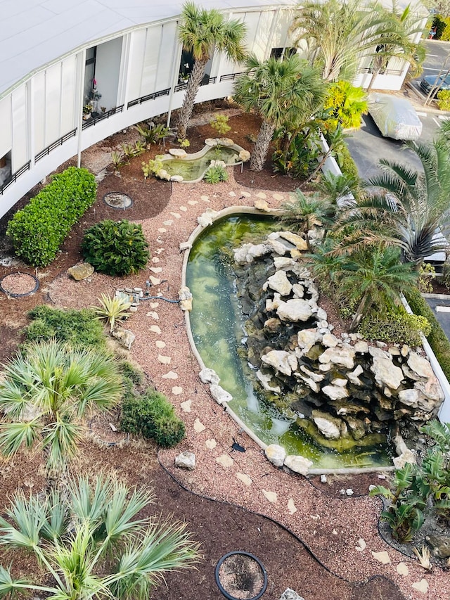 view of yard featuring a garden pond