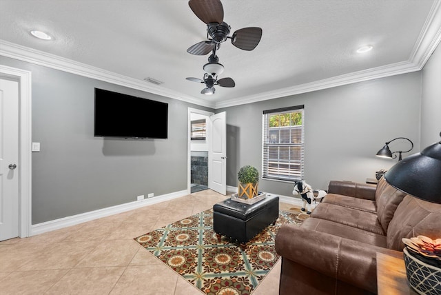 tiled living room featuring ceiling fan, a textured ceiling, and ornamental molding