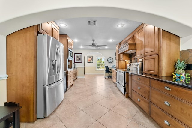 kitchen featuring ceiling fan, light tile patterned floors, and appliances with stainless steel finishes