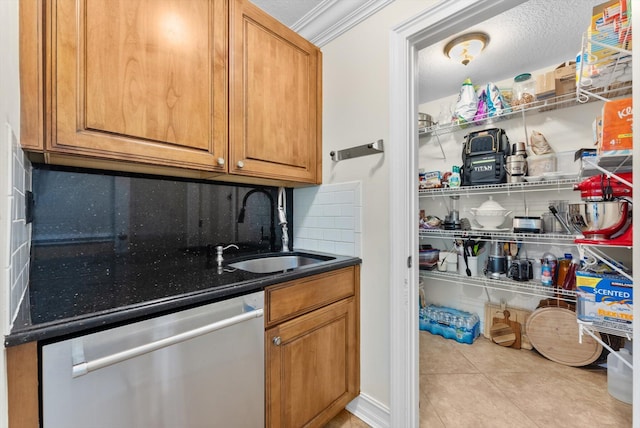 kitchen featuring dishwasher, sink, crown molding, a textured ceiling, and light tile patterned flooring