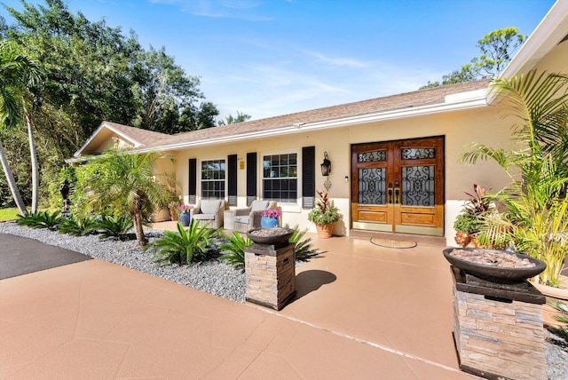 exterior space with french doors and a porch