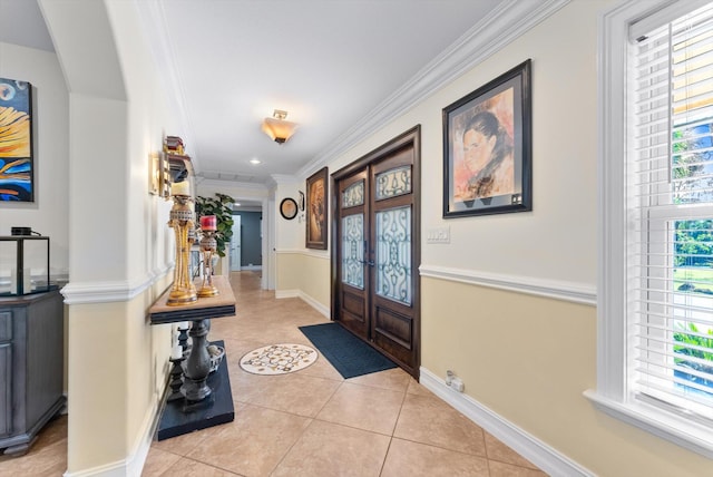 entrance foyer with french doors, light tile patterned floors, and ornamental molding