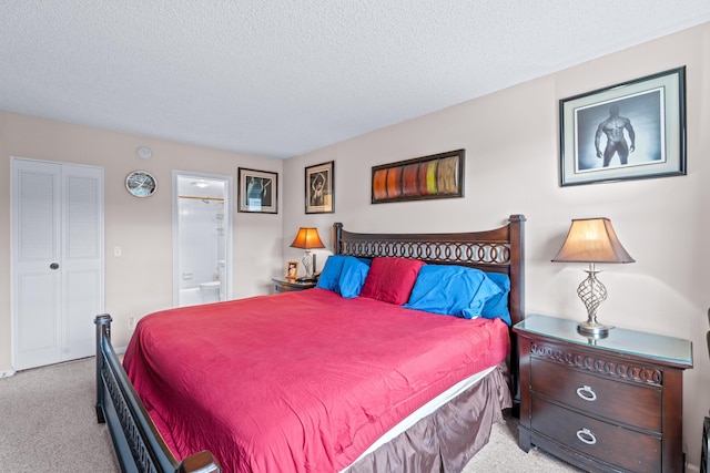 bedroom with ensuite bathroom, a closet, light colored carpet, and a textured ceiling