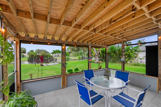 unfurnished sunroom featuring a water view