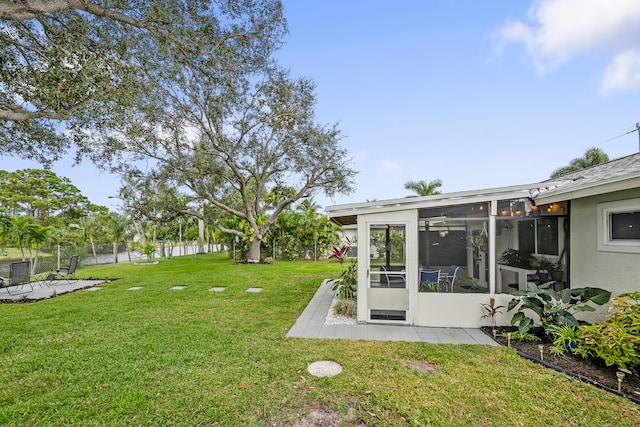 view of yard featuring a patio area and a sunroom