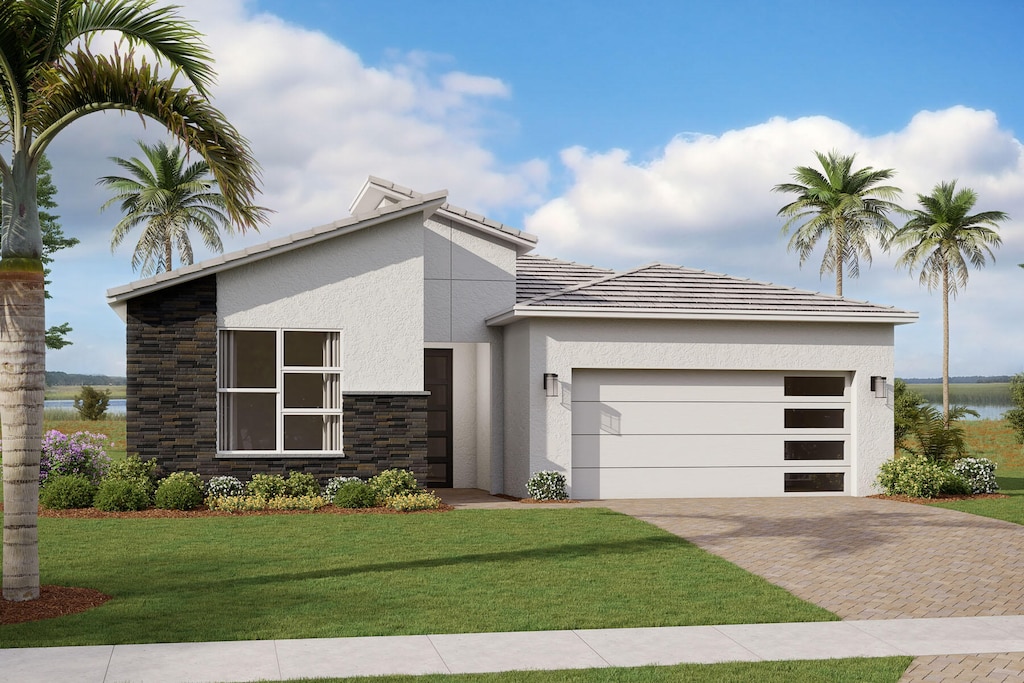 contemporary house featuring a water view, a front yard, and a garage