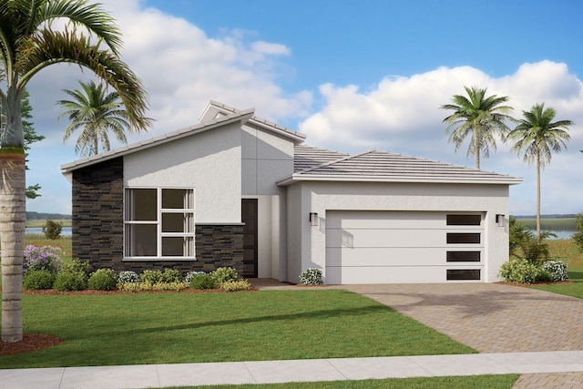 contemporary house featuring a water view, a front yard, and a garage