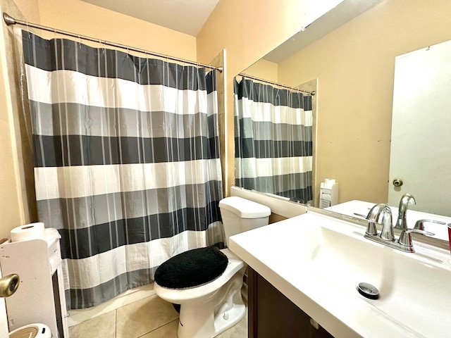 bathroom featuring tile patterned flooring, a shower with curtain, vanity, and toilet