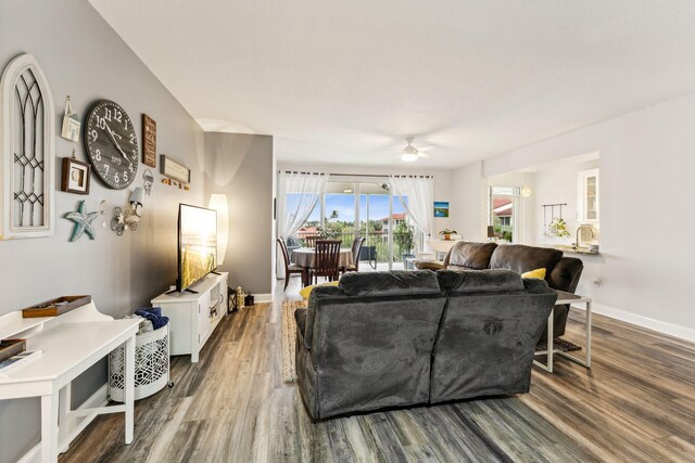 bedroom with ceiling fan, visible vents, baseboards, a closet, and dark wood-style floors