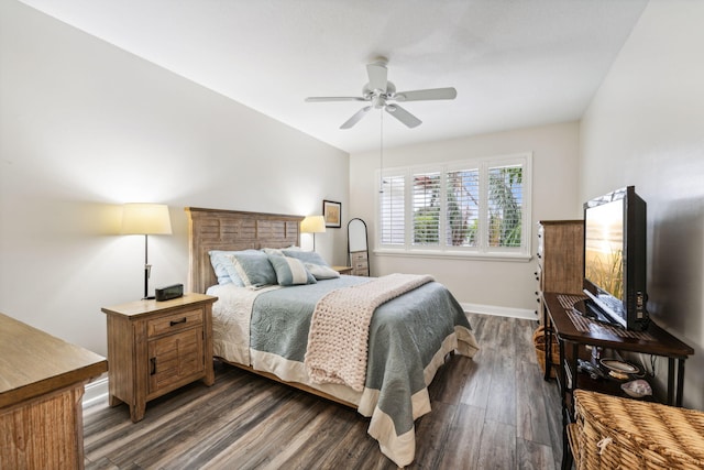 bedroom featuring a ceiling fan, baseboards, and dark wood-style flooring