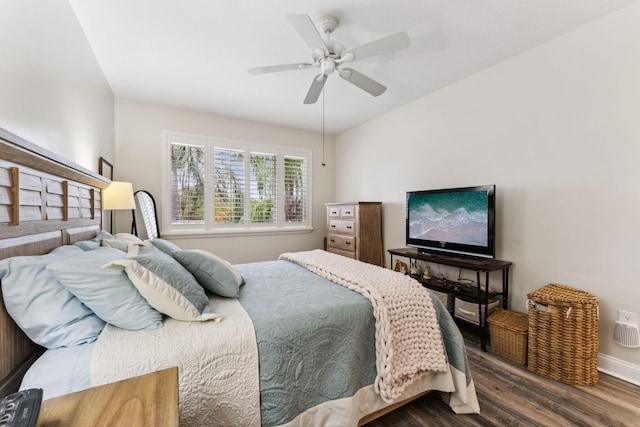 bedroom featuring wood finished floors, a ceiling fan, and baseboards