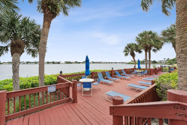 wooden deck featuring a water view and outdoor dining area