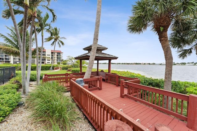 wooden deck with a water view and a gazebo