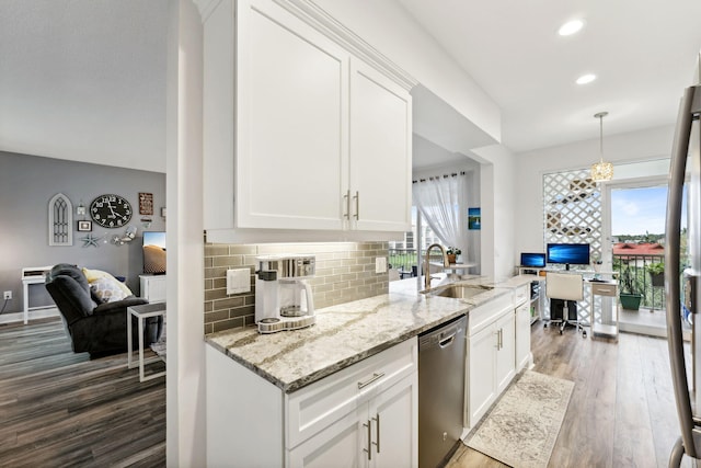 kitchen with stainless steel dishwasher, backsplash, a sink, and a healthy amount of sunlight