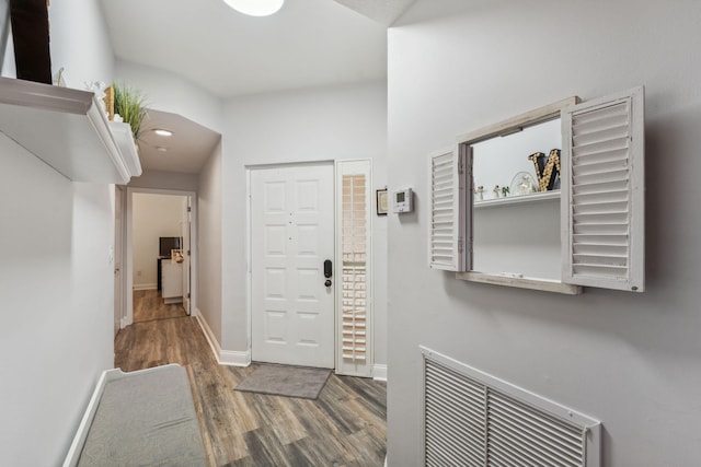 entrance foyer with visible vents, baseboards, and wood finished floors