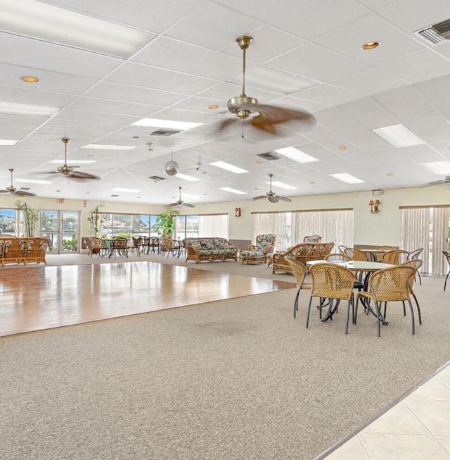 dining room featuring a paneled ceiling and light tile patterned floors