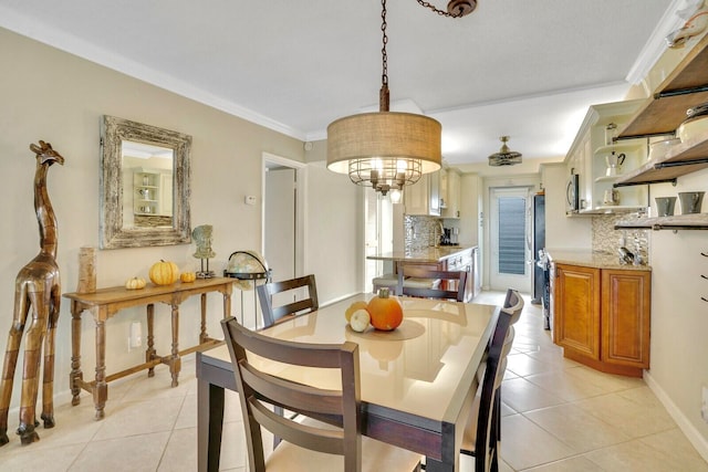 tiled dining area featuring ceiling fan and ornamental molding