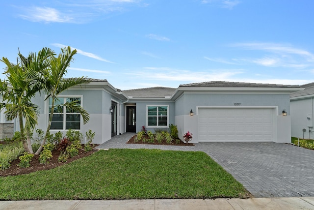 view of front of house with a garage and a front yard