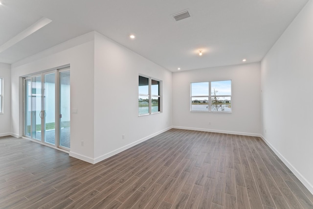 empty room featuring dark hardwood / wood-style flooring