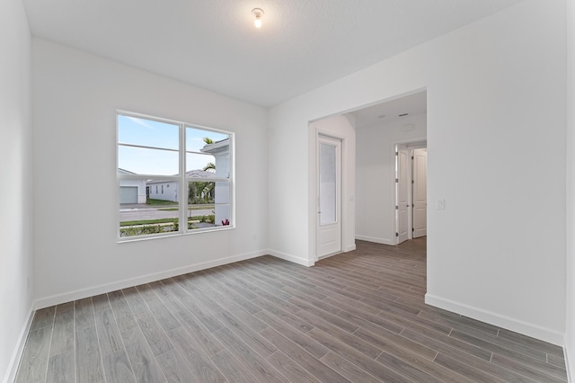 unfurnished room with hardwood / wood-style floors