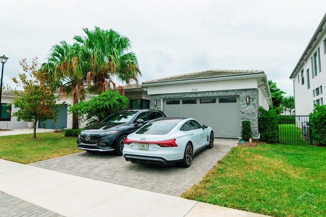 view of front of property with a front lawn and a garage